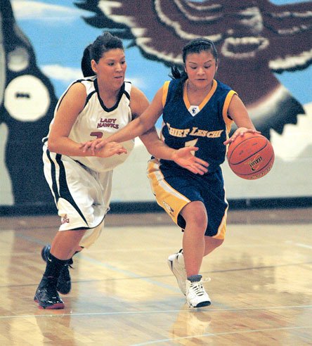 Heritage guard Shylee Burke applies the back court pressure on Chief Leschi's Lena Hawkins that helped the Hawks get back to .500 (3-3).