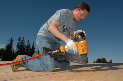 Jonathan Bontoft nails down the new roof of the refurbished baseball dugout at Shoultes Elementary Sept. 3.