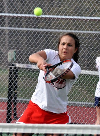 M-P senior Katie Peterson hits the ball high in the air to get into better position.