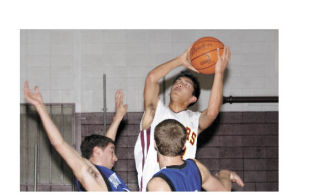 Lakewood Junior Joseph Hawkins attempts a shot while being heavily guarded by South Whidbey defenders.