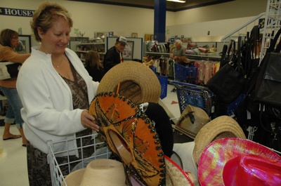 Karen Miller examined cowboy hats at the Marysville Goodwill's 'Western Days' last year.