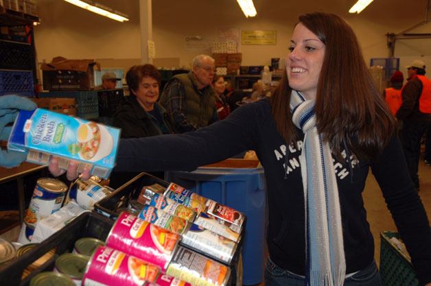 Megan Morales shops for a Marysville Community Food Bank client on Nov. 16 and gets them some chicken broth.