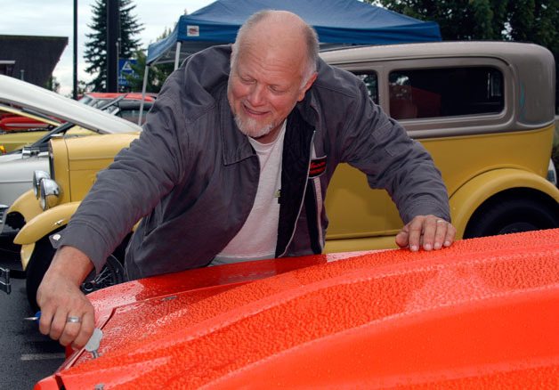 Smokey Point’s David Edwards seals up the hood of his 1972 Pontiac Ventura drag racer at Sound Harley-Davidson on July 17.