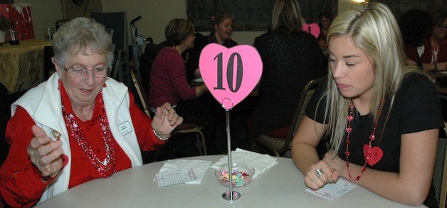 Alice Demmig and Ivy Jacobsen play Bunco to raise money for the Soroptimists.