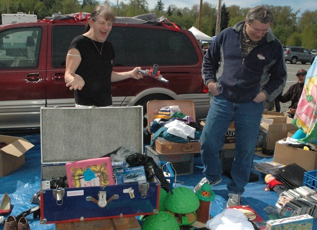 Vendor Joe Whitney is all smiles as he seeks to sell his merchandise to shopper Wes Maleta at the Boom City Swap Meet in Tulalip on April 26.