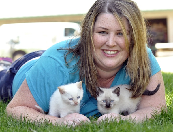 Marissa Brugger holds two four-week-old foster kittens whose lives were saved through the N.O.A.H. foster program.