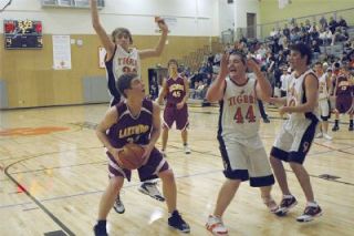 Lakewoods Billy Rist tries to find an opening under Granite Falls basket.