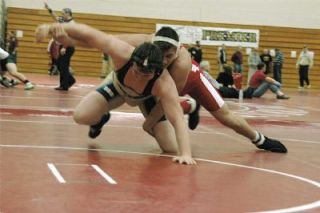 M-Ps Tannon Hillis tries to keep Arlingtons Richard Perkins on the mat. Hillis emerged with the win on the way to a victory in the 215-pound bracket at the M-P Premier Jan. 12. Perkins finished third.