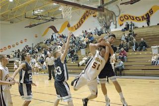 Senior Max Dragich gets fouled hard under the basket during the first quarter of Lakewoods 68-55 loss to Sultan.