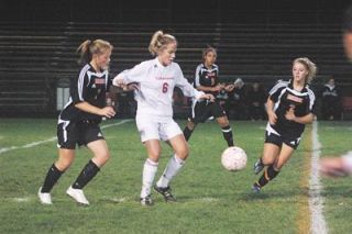 Senior Hannah Wood dribbles through the Monroe defense.