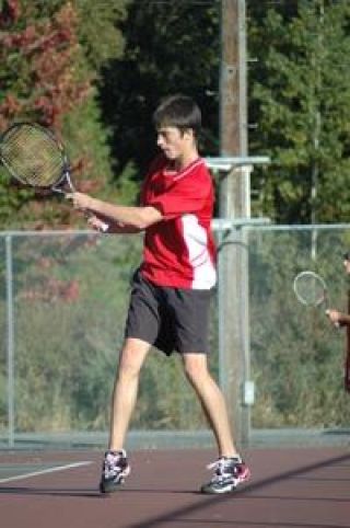 Sophomore Kyle Hanks gives it his all in his No. 4 singles match against Arlington Wednesday