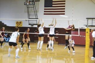 Amanda Gregory swings down on a kill for the Lakewood Cougars in their match against Granite Falls.
