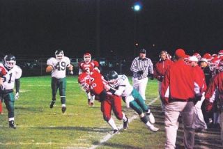 M-P running back Ryan Sterley tries to head up field while being tackled by Edmonds-Woodways Ryan McCartney during the Warriors 21-10 victory over the Marysville-Pilchuck Tomahawks Oct. 19. Sterley ran for 61 yards on 12 carries.