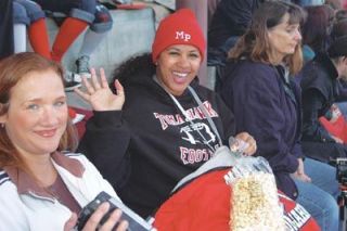 Dahlila Stell waves from her familys seat above the Tomahawk 50-yard line.