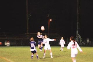 Sophomore defender Rachel Hamelin vies with Oak Harbors Hope Thompson to butt the ball toward her teammates.