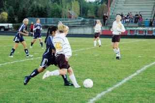 Amanda Nunley crosses a ball to a waiting Erin Dierickx. The Cougars soccer team continued their strong play of late