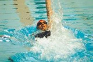 Sophomore Kami Girard strokes her way to a seventh-place finish in the 100-yard backstroke Saturday
