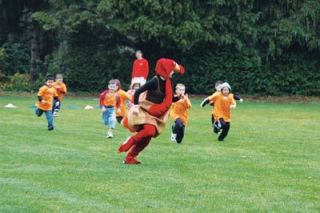 Kindergarteners chase turkey/M-P student Roxanne Trocino.