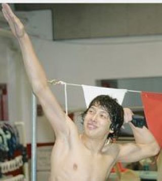 Senior swimmer Keito Swan flexes his muscles at a recent swim practice.