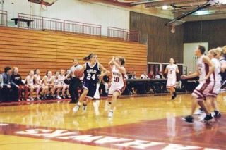 Senior Anna West throws up her arms to defend against Kamiak guard Taige Kussman.