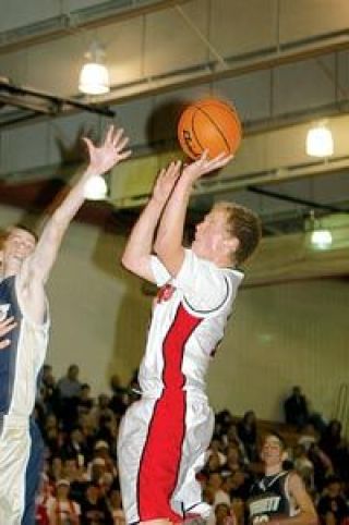 Senior guard and forward Ricky Holm shoots a fadeaway jumper Tuesday