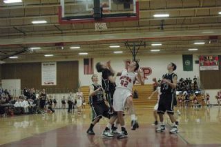 Senior center Taylor Stevens and three Jackson defenders watch to see whether Stevens basket is good.