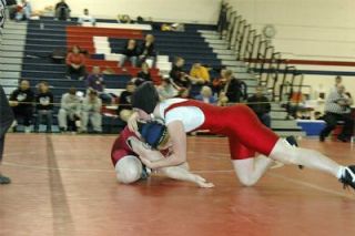 M-P senior Robin Mueller takes Cascades Rachel Tomczyk to the mat