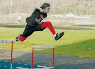 M-P sophomore Caleb Posey works on his hurdling form during an afternoon practice at the Tomahawk track.