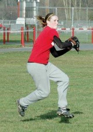 Junior outfielder Anna West hurls a ground ball back infield.