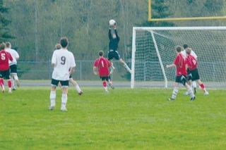 Its Air Karrenberg as Lakewood junior goalkeeper Peter Karrenberg gets some elevation in his leap to stop an attempted Coupeville score.