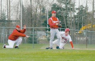 Designated hitter Ricky Holm slides into third against Stanwood