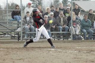Designated hitter Marissa Lewis slams her game-winning homer in the bottom of the seventh inning. With teammate Anna West on base