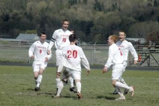 An ecstatic M-P team celebrates Ryan Wilsons second goal at midfield. From left