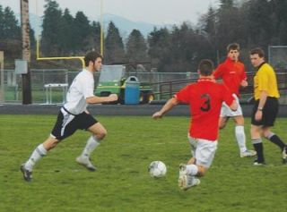 Senior defender Kelvin Mansfield weaves through traffic with the ball.  Mansfields key goal propelled Lakewoods team to victory over Granite Falls