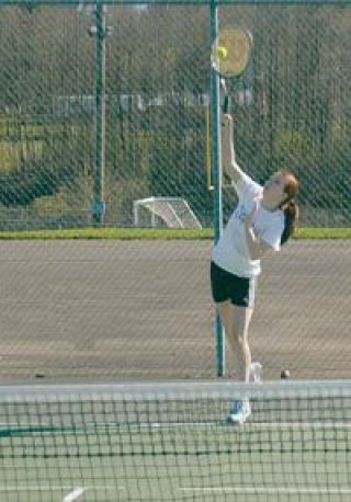 Kayla Desmond powers in a serve against her South Whidbey opponent Meole Zalewski during their match on March 26.
