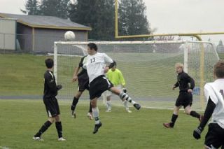 Junior forward Evander Ochoa bumps the ball