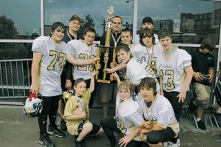 The championship Marysville Wolverines hoist their trophy. Bottom row from left