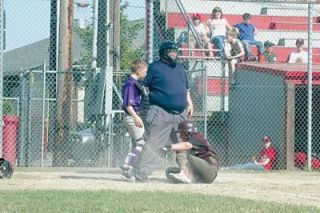 Outfielder Dez Ritcheson picks himself up at home after sliding in for his first fourth-inning run. Ritcheson had a double and an RBI in his second at bat for Walker Coffee Company during the second day of Strawberry Tournament play.