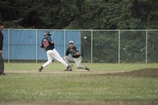 Shortstop Kekoa Riggen grabs a long throw from catcher Dustin Ward to keep a Burlington baserunner at second.
