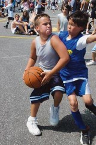 Determined local athlete Cody Kallstrom pushes past Leif Anderson for a shot at the basket.