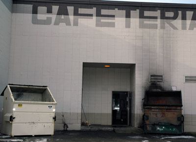 Smoke from a fire set in a dumpster blackened the outside wall of the cafeteria at Totem Middle School Monday morning.