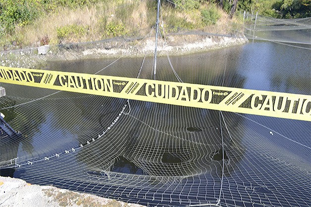 A pickup crashed over a barrier and landed on this net upside down