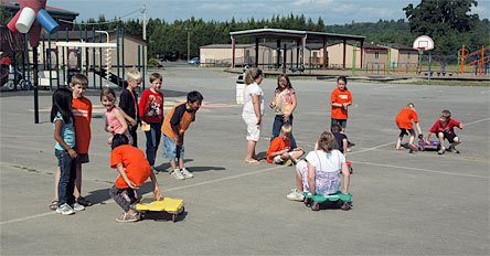 Students in the Kellogg Marsh Elementary fitness club do relay-races on scooter-boards to give them a workout June 11.