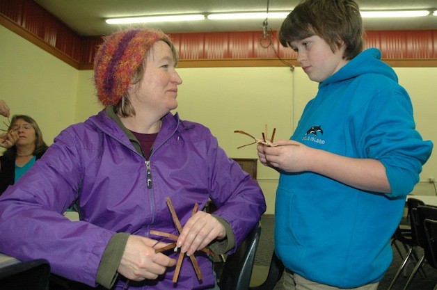 Marysville's Chandra Dunne weaves cedar medallions with her 9-year-old son