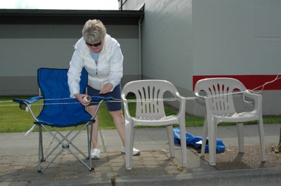 Kim Williams makes sure no one else sits in the chairs that she's set out on State Avenue to watch the Marysville Strawberry Festival Grand Parade.
