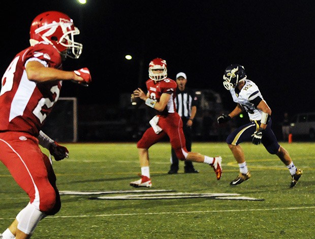 Marysville-Pilchuck quarterback Erik Lind rolls out to pass.