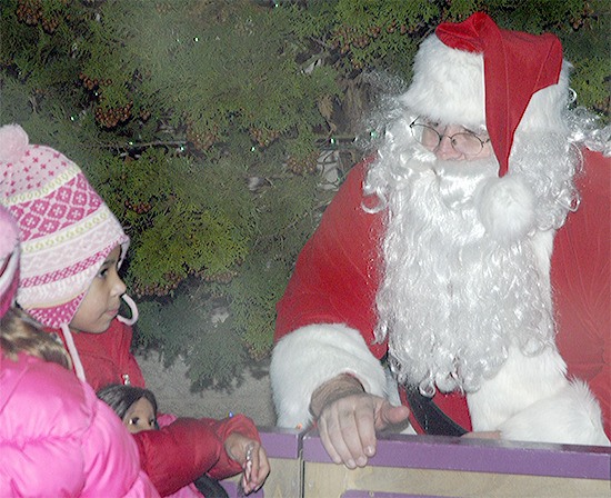 Santa visits with children at the Tour of Lights at Cedarcrest Golf Course in Marysville. The Christmas light show takes place the next two weekends.