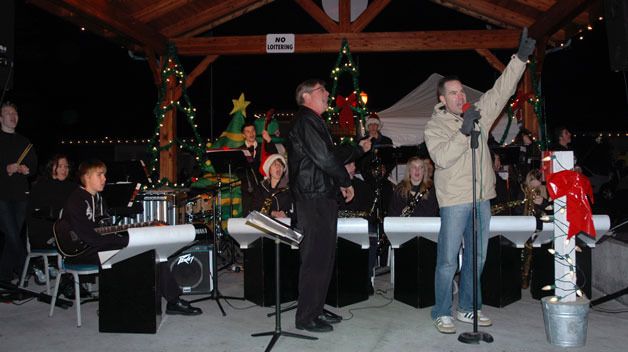 Marysville-Pilchuck High School Band Director John Rants watches as Marysville Mayor Jon Nehring counts down to the lighting of the Marysville water tower for ‘Merrysville for the Holidays’ Dec. 4.
