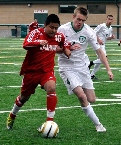 M-P’s Omar Flores speeds past a Woodinville player during the March 16 game at Pop Keeney Stadium in Bothell.