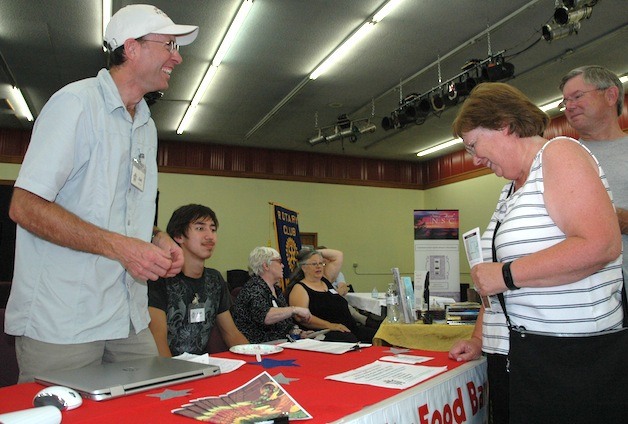 Dell Deierling and Josh Brown of the Marysville Community Food Bank chat with Jan and Les Liner about becoming volunteers.
